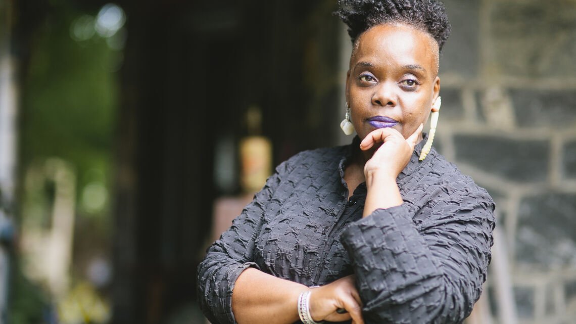 person dressed in black looking beyond camera