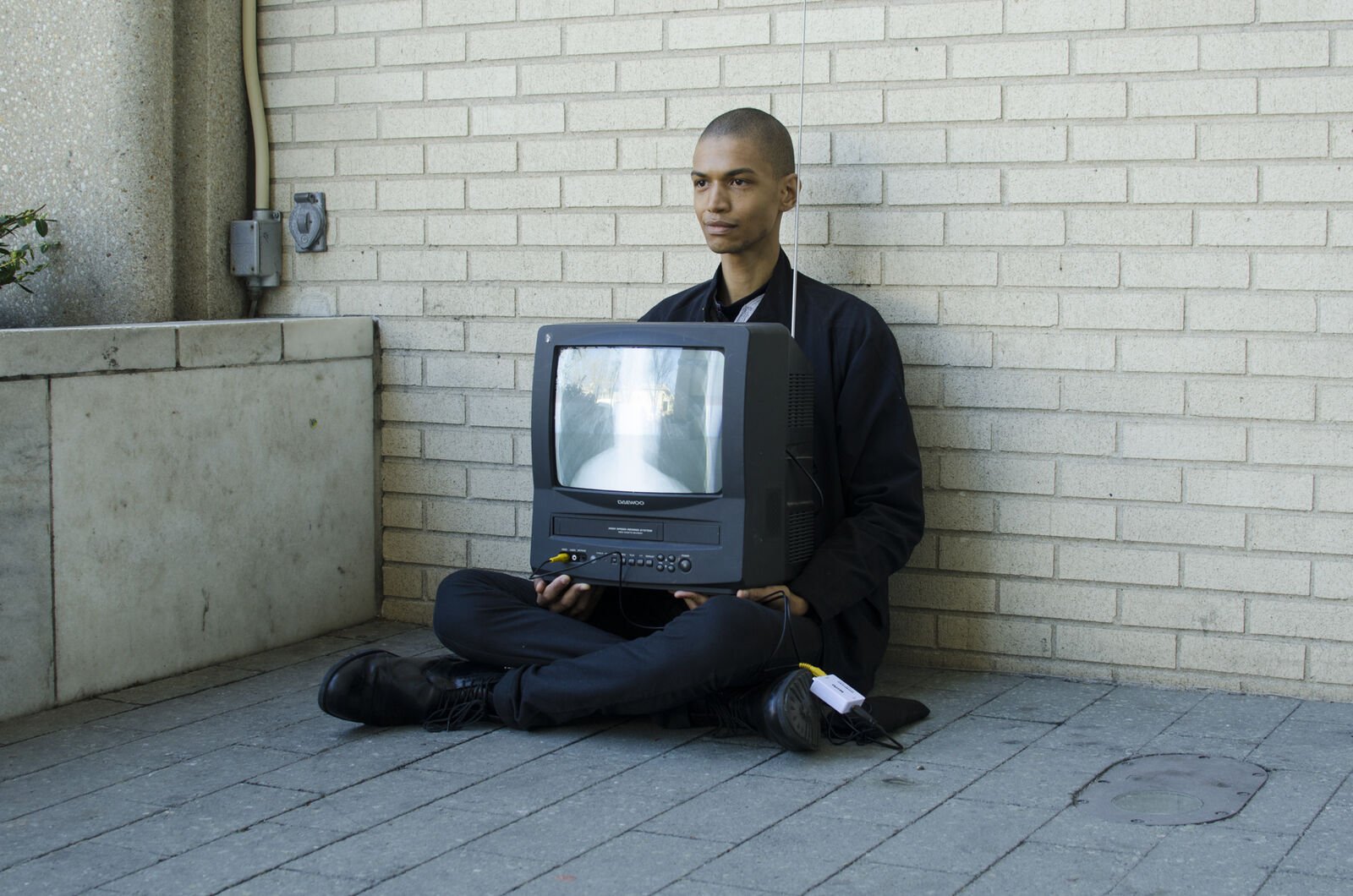 person sitting on floor holding a television